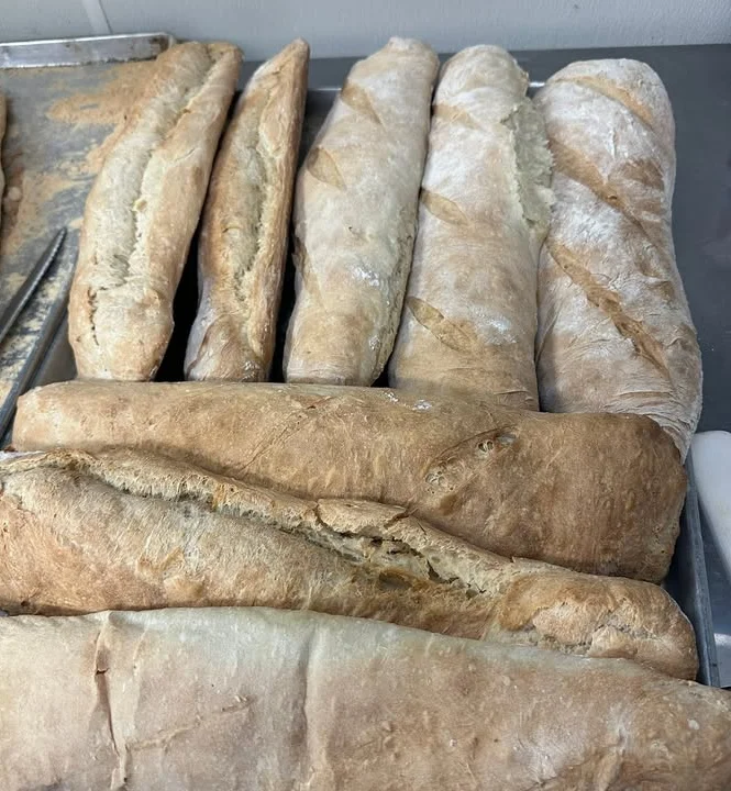 Freshly baked French baguettes on a tray