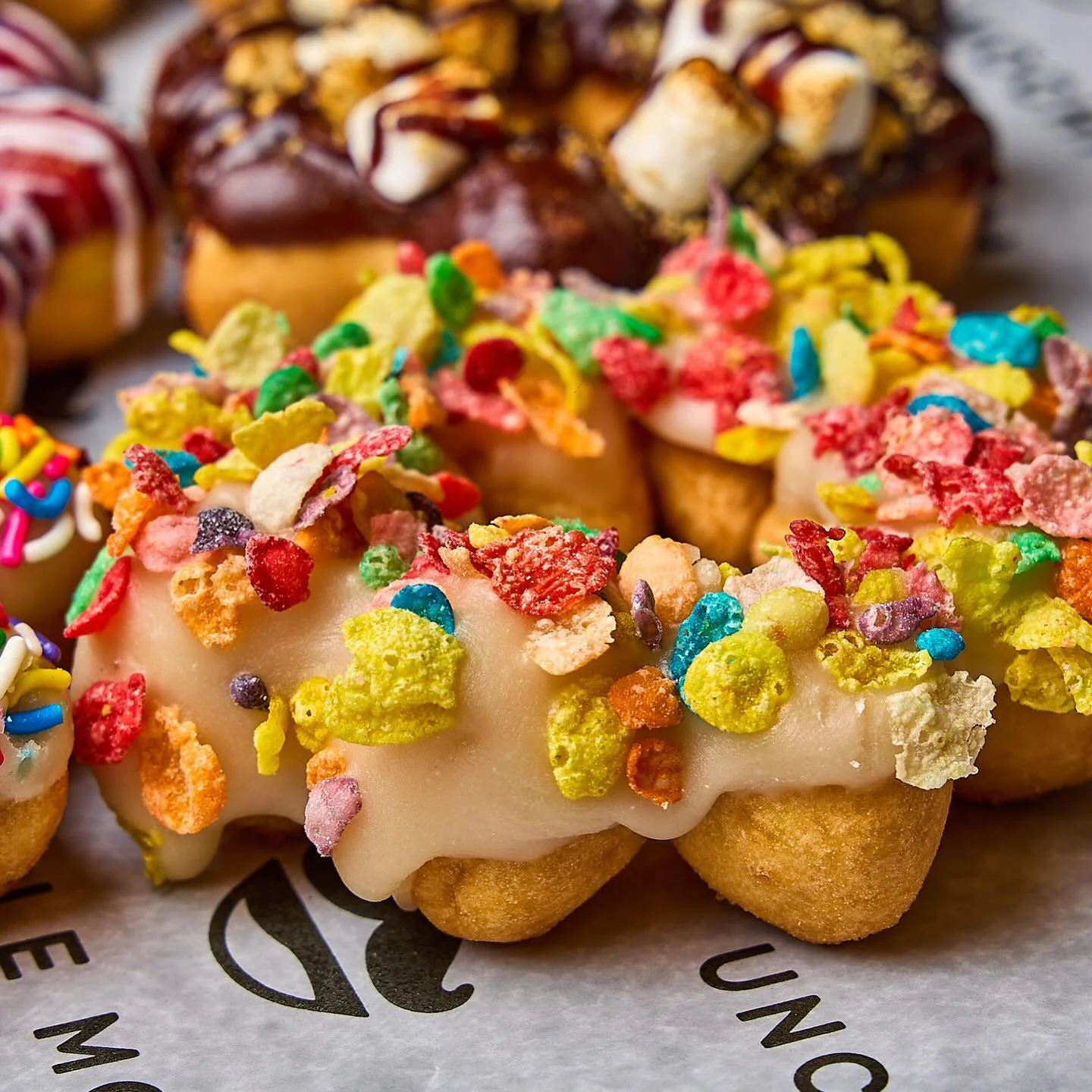 Colorful cereal-topped donuts on display