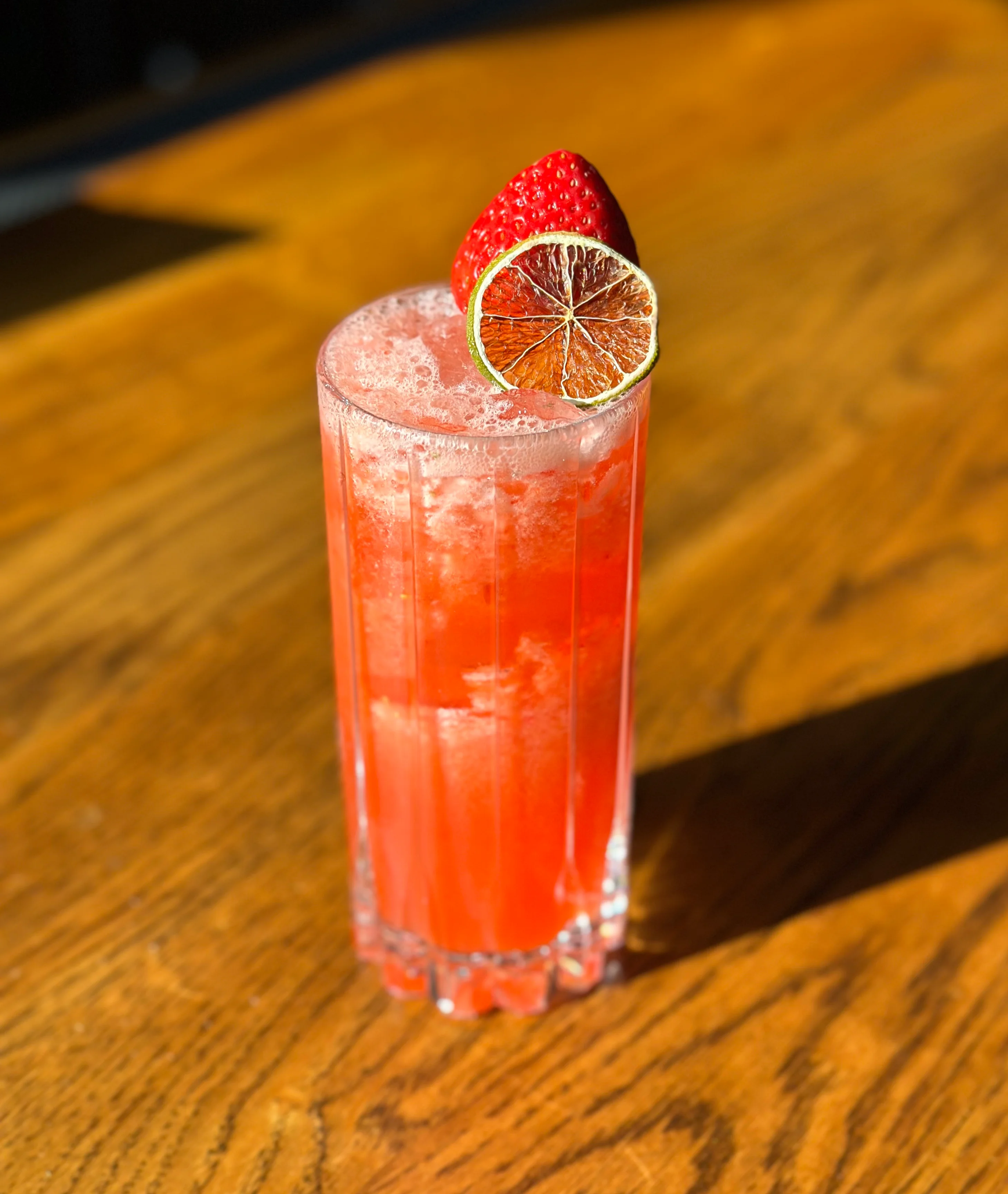 Refreshing strawberry cocktail with lime garnish