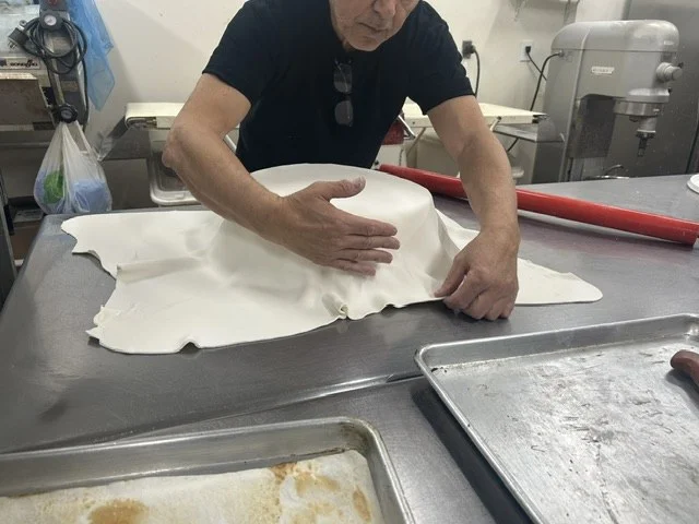 Baker rolling fondant in The Kosher Pastry Oven kitchen