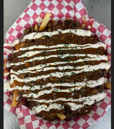 Loaded fries with barbecue sauce and creamy drizzle