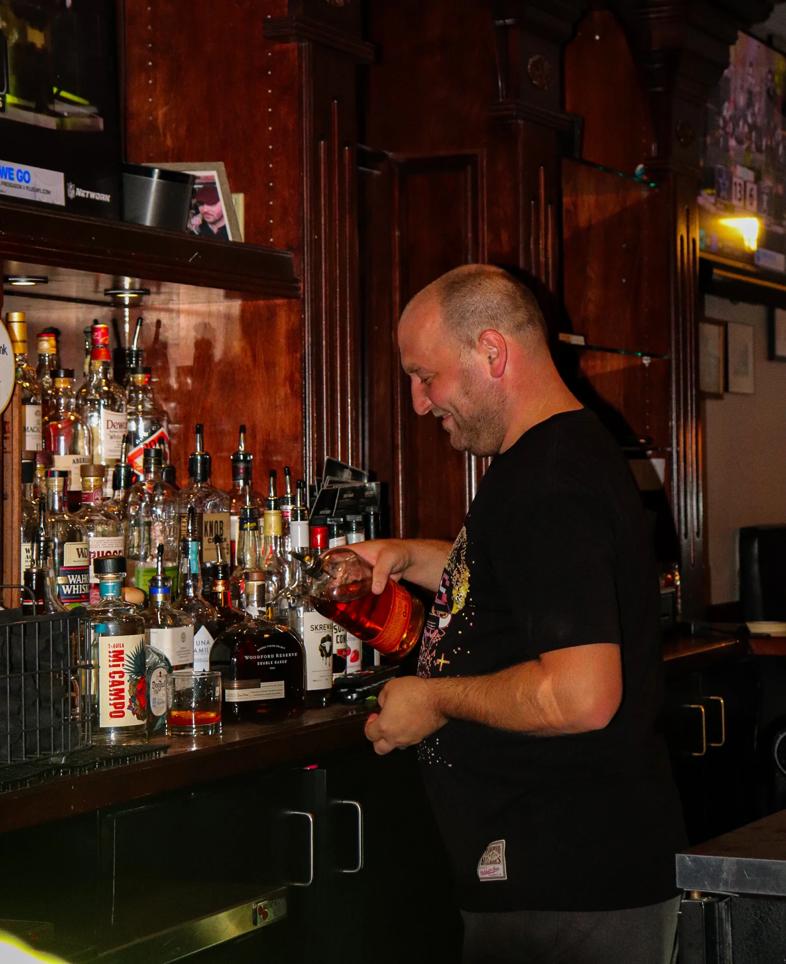 Bartender pouring a cocktail at a stylish bar