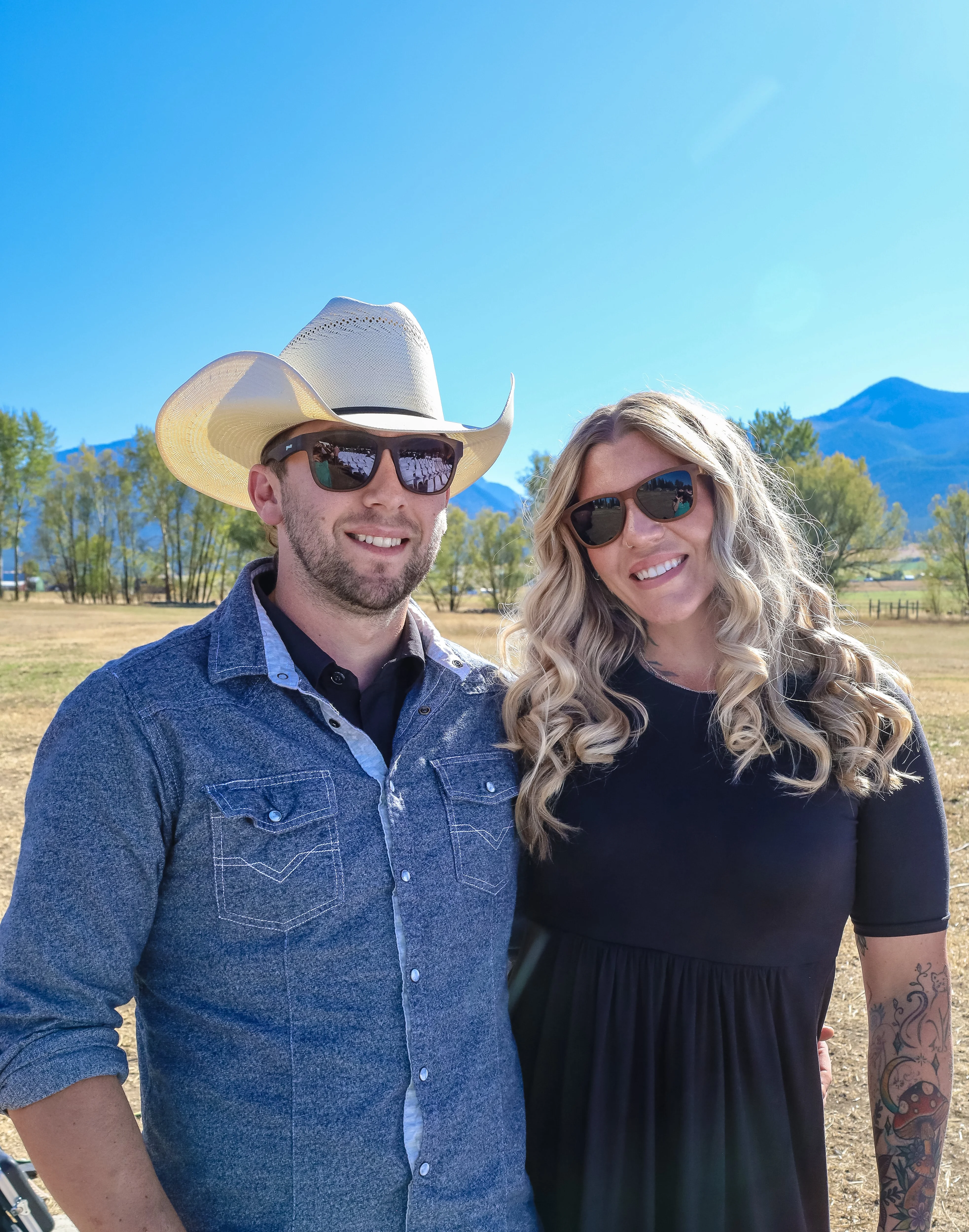 Couple posing outdoors in sunny mountain setting
