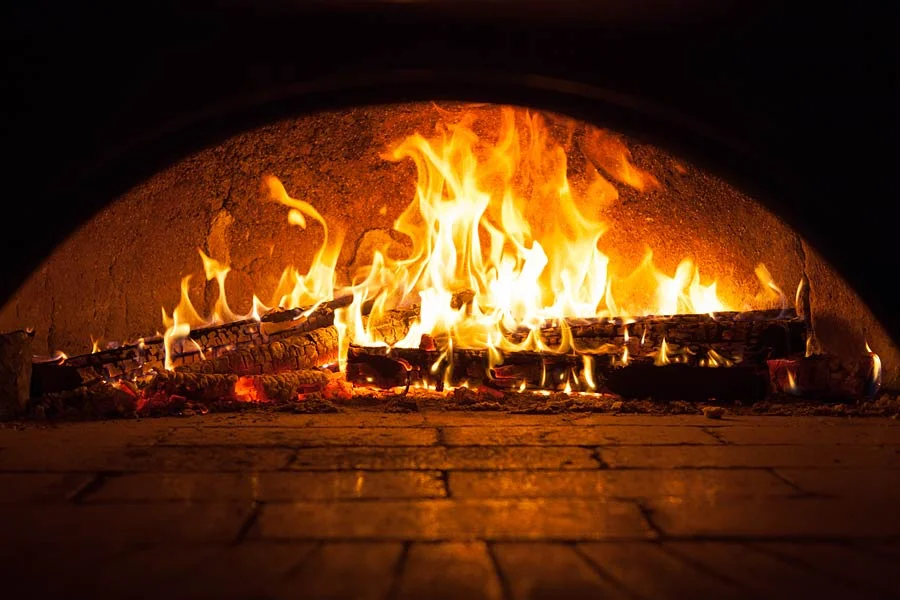 Flames dancing in a traditional wood-fired oven