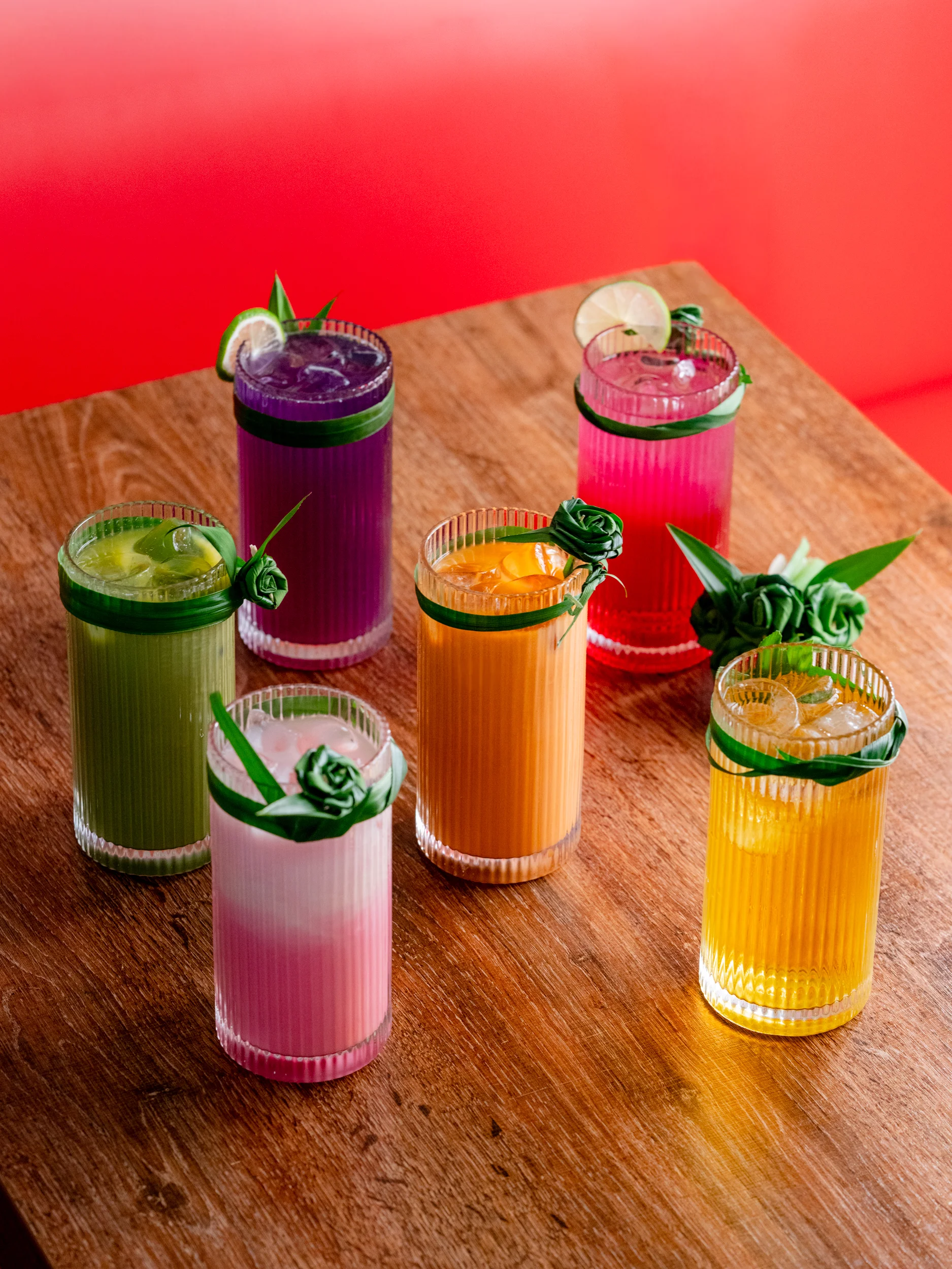 Colorful assortment of refreshing cocktails on a wooden table
