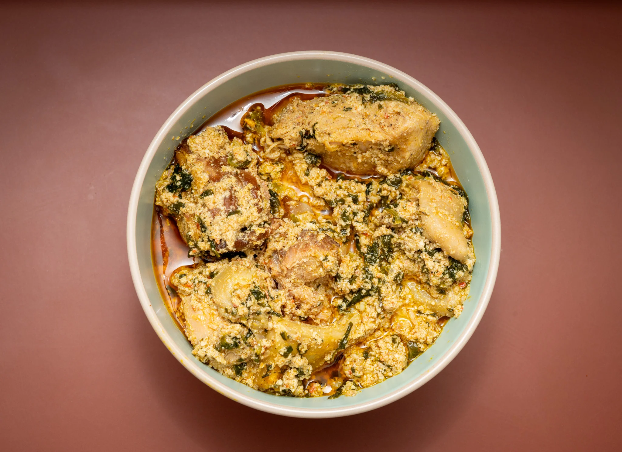 Nigerian egusi soup with meat and leafy greens