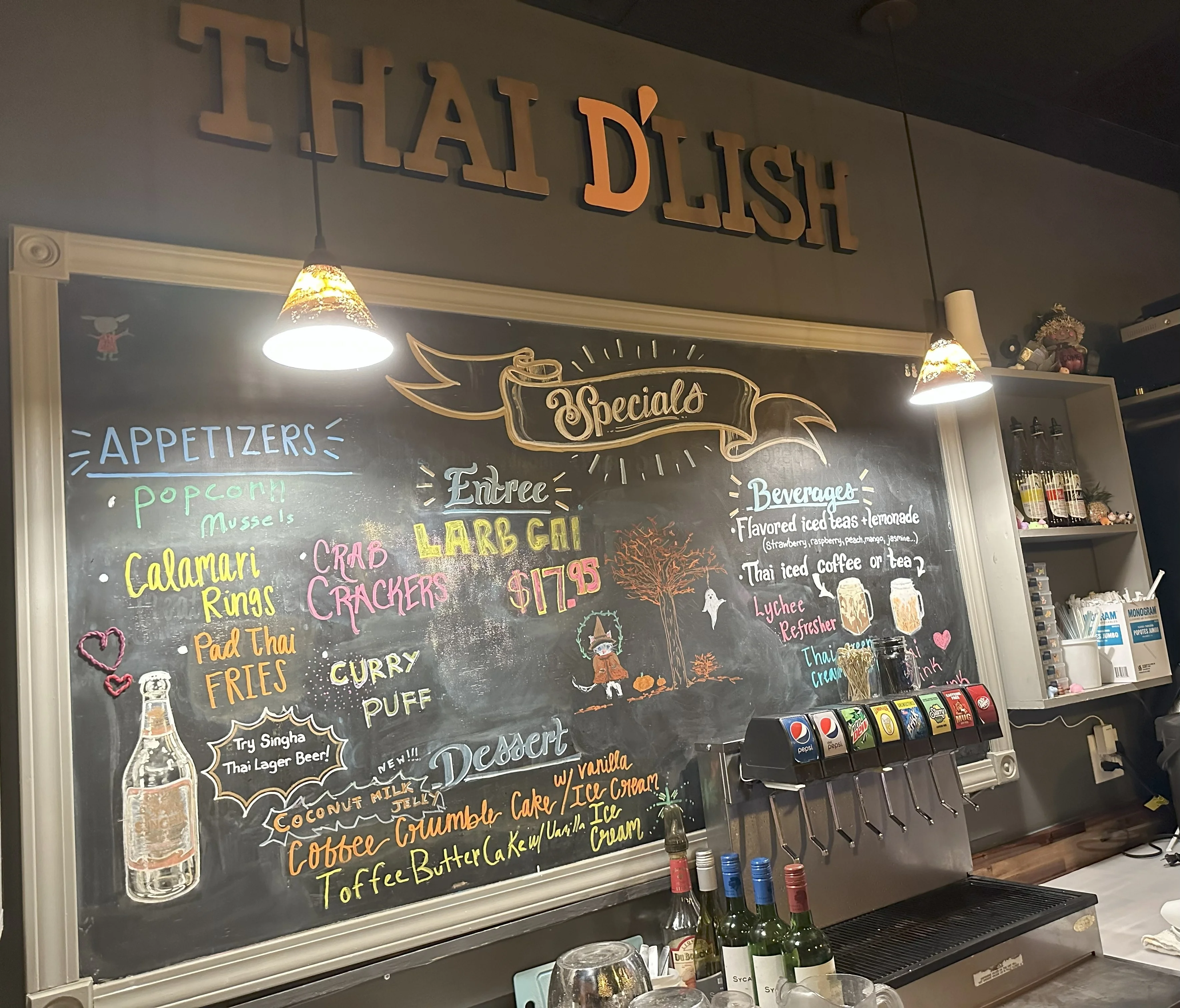 Chalkboard menu at Thai restaurant featuring Larb Gai and appetizers