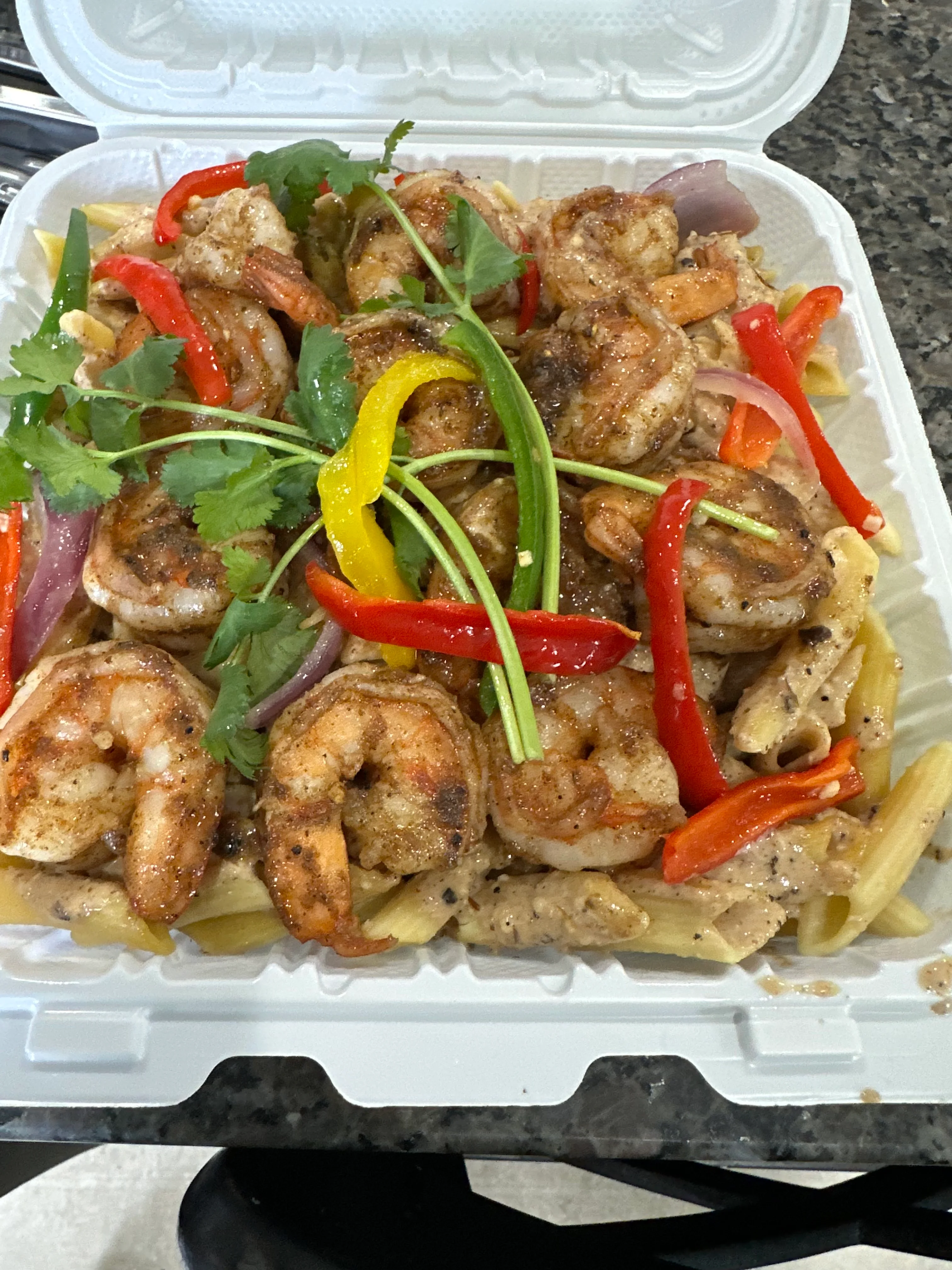 Shrimp pasta with colorful peppers and herbs