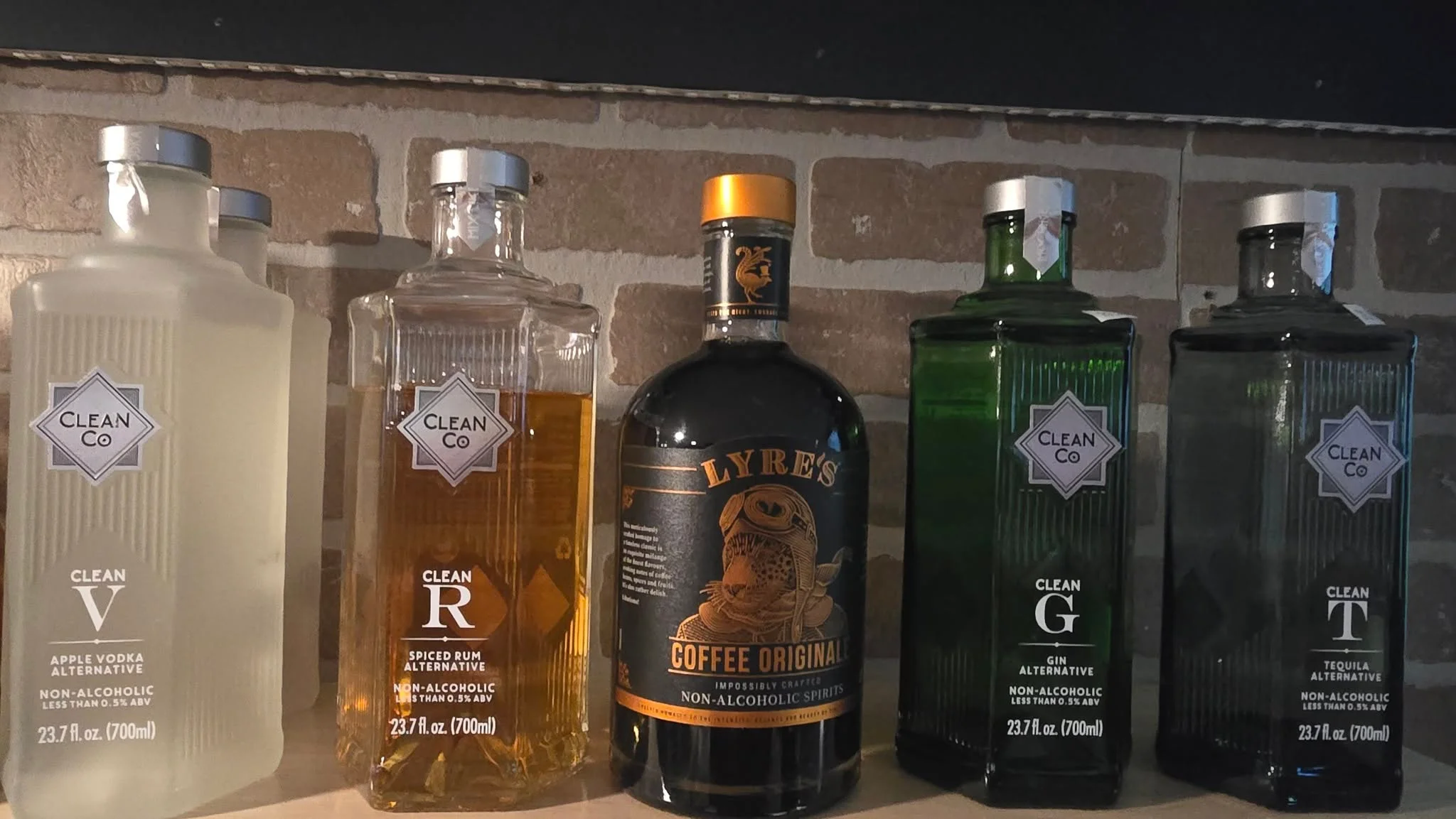 Selection of non-alcoholic spirits on a bar shelf