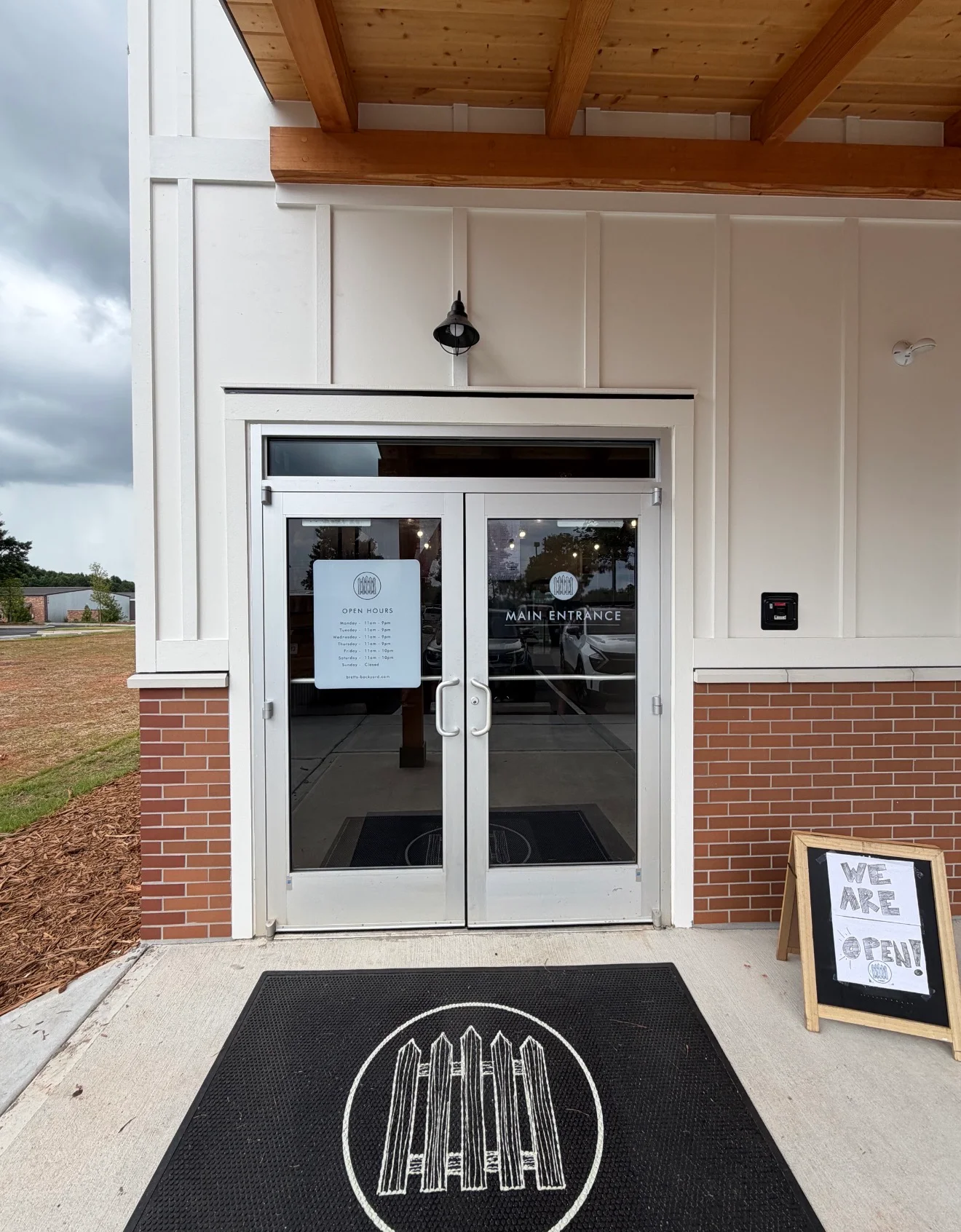 Restaurant entrance with welcoming sign and modern design