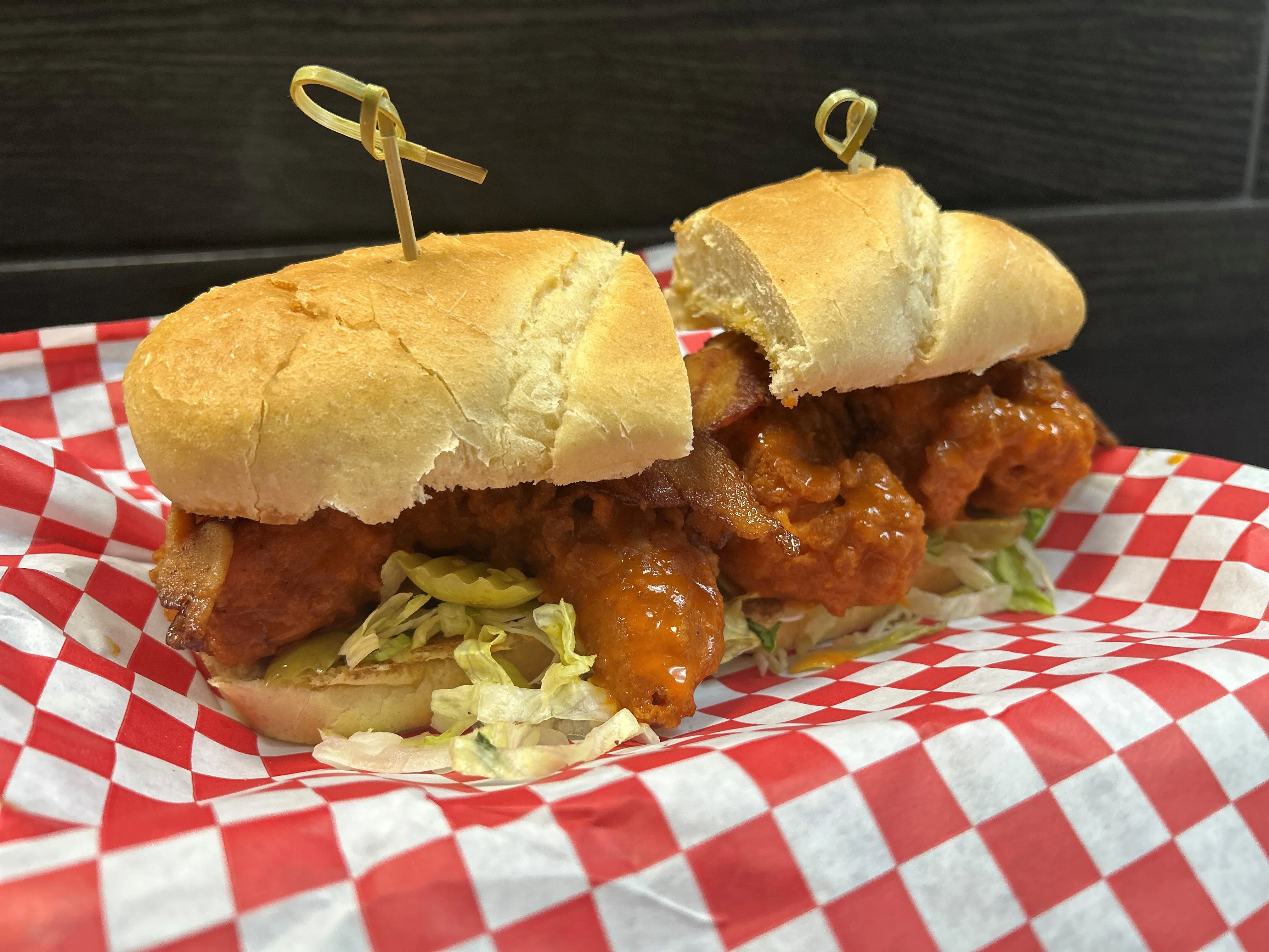 Spicy chicken sandwich with lettuce on a checkered paper