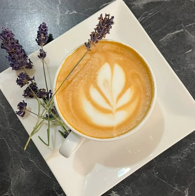 Lavender latte art in a cozy café setting