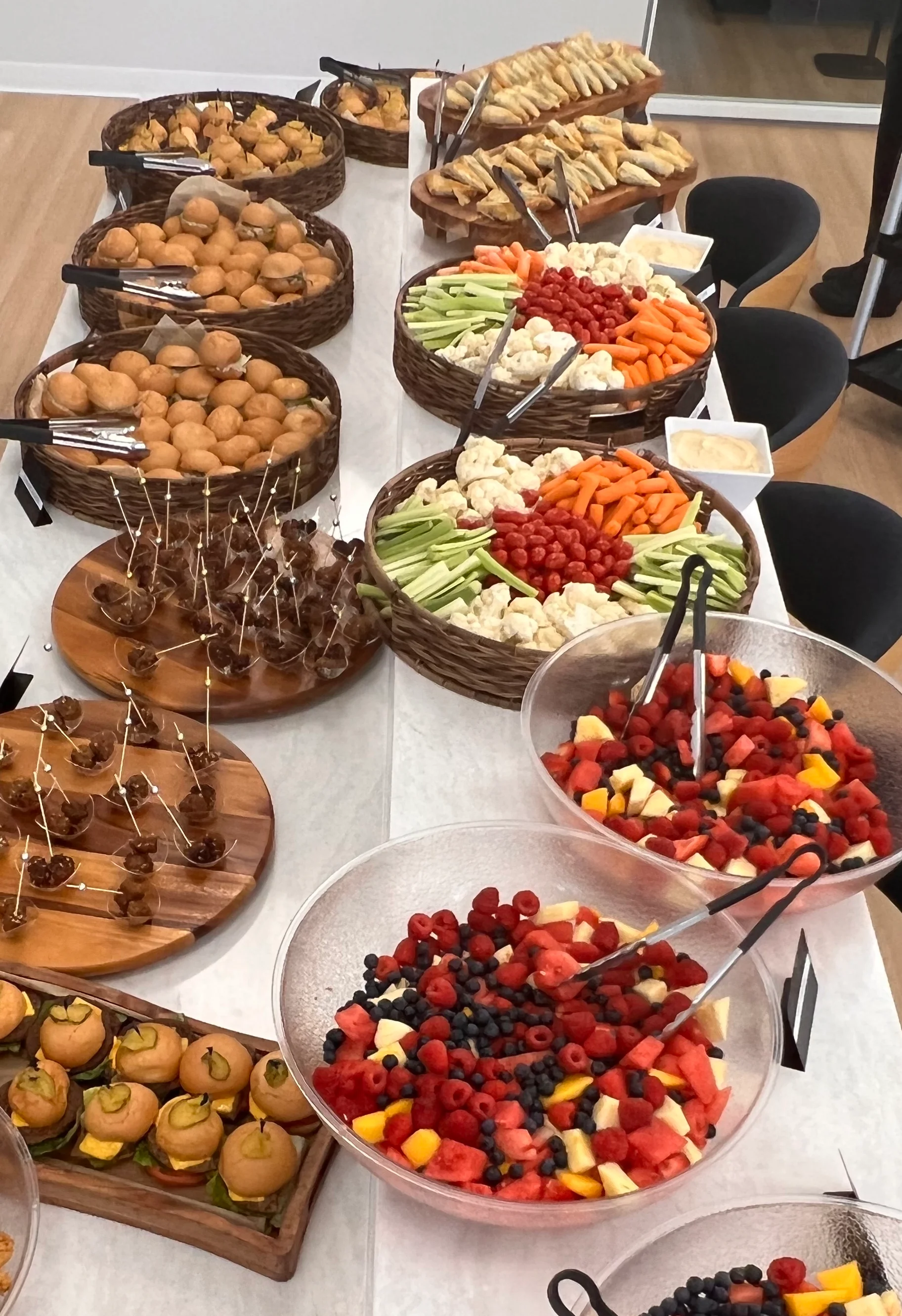 Assorted buffet spread with appetizers and fresh fruit