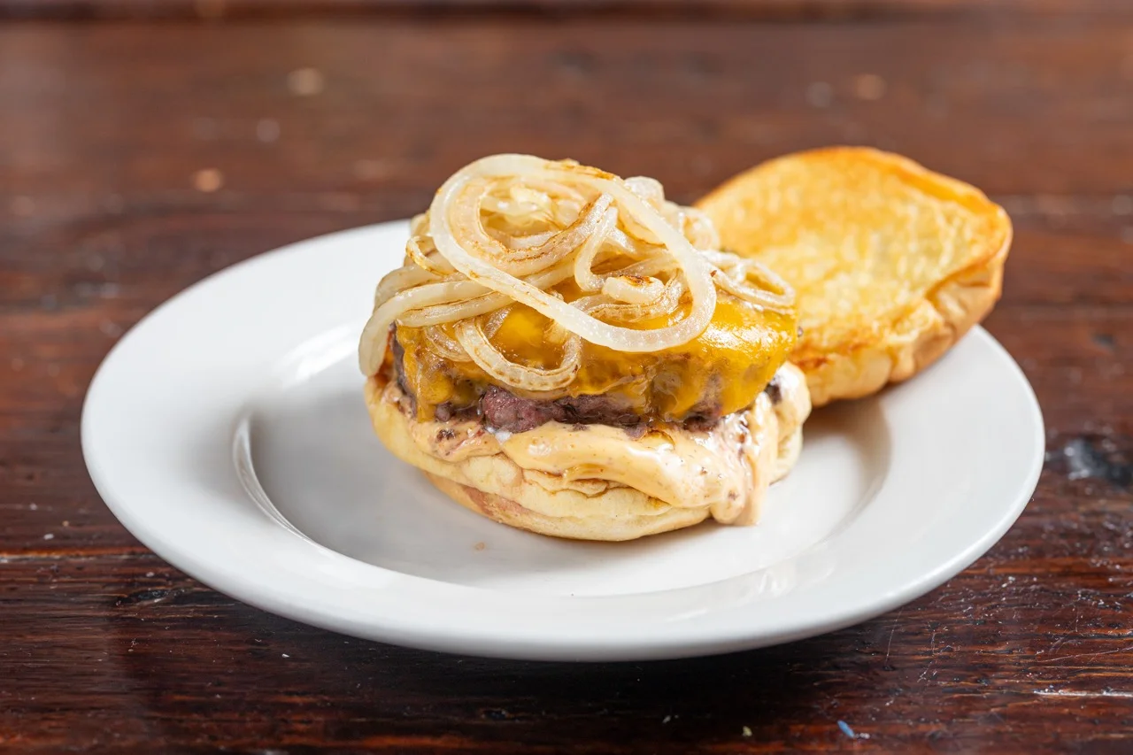 Juicy cheeseburger with grilled onions on a toasted bun