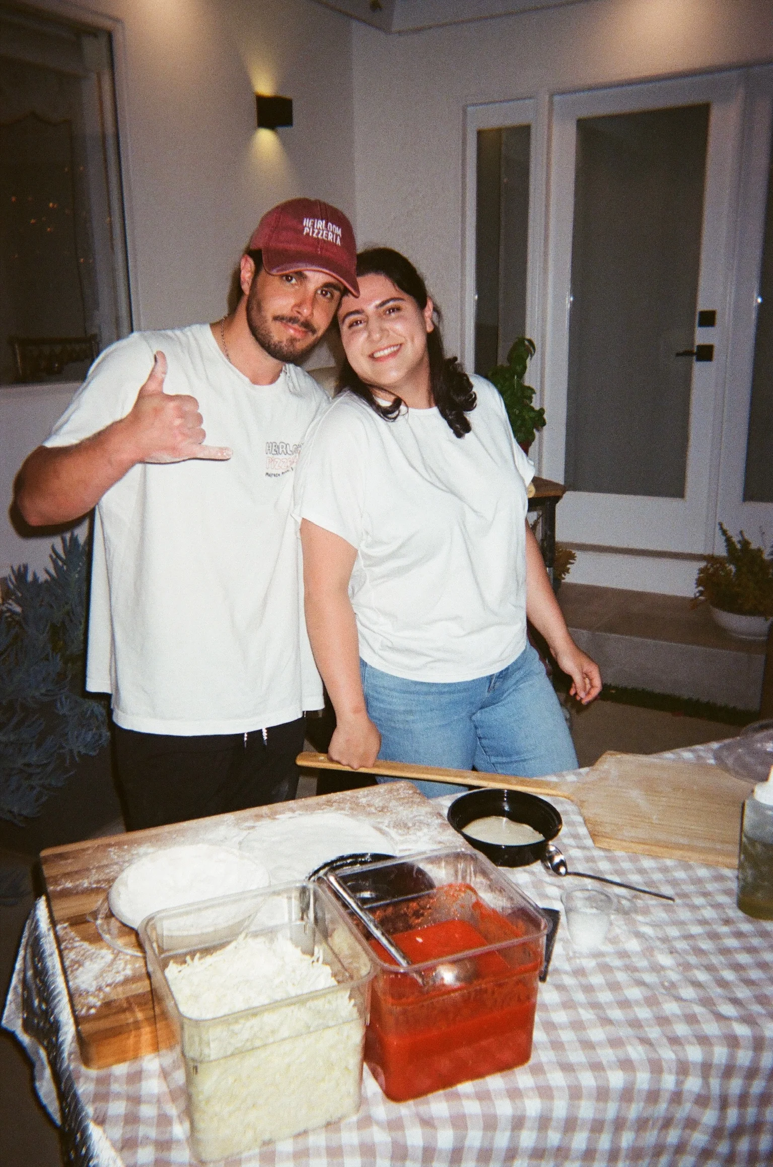 Making homemade pizza with friends in a cozy outdoor setting