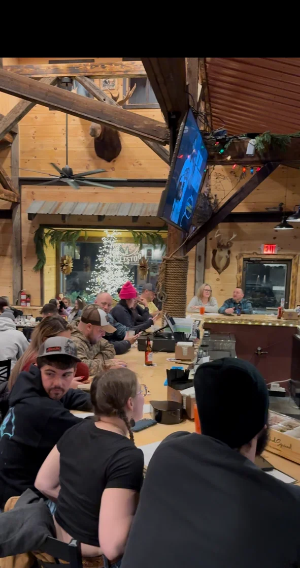 Cozy restaurant interior with wooden decor and festive lighting