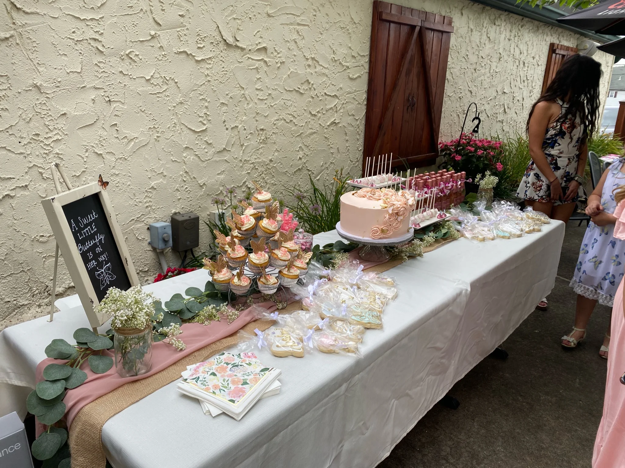 Dessert table with cupcakes and a pink cake for a celebration