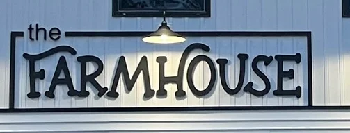 Exterior view of The Farmhouse restaurant with modern design and warm lighting