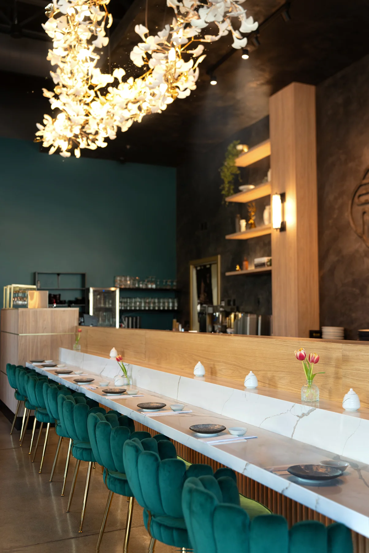 Stylish restaurant interior with green velvet chairs and elegant lighting