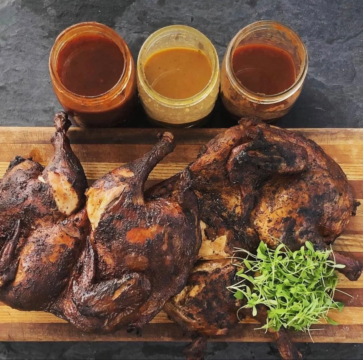 Smoky Peruvian pollo a la brasa with dipping sauces