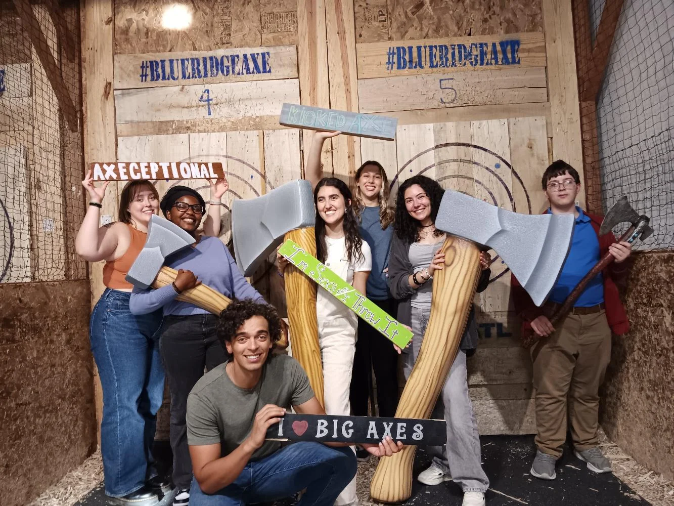 Group of friends enjoying axe throwing at a fun venue