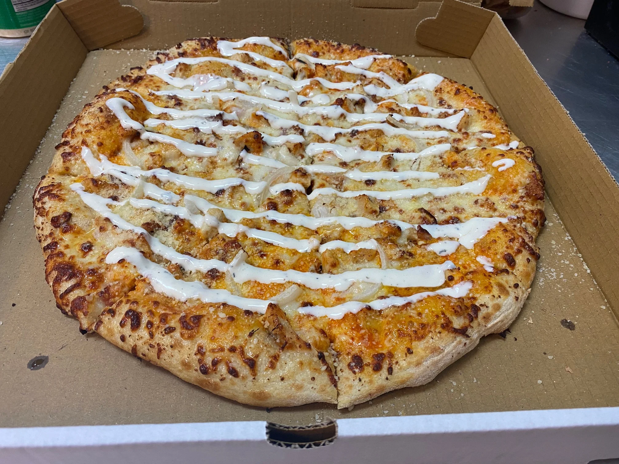 BBQ chicken pizza drizzled with ranch dressing
