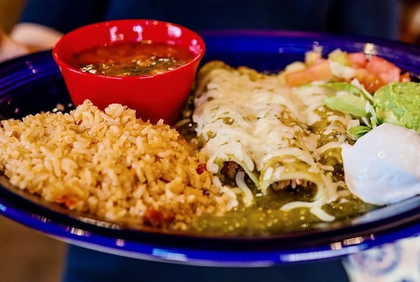 Plate of enchiladas verdes with rice and beans