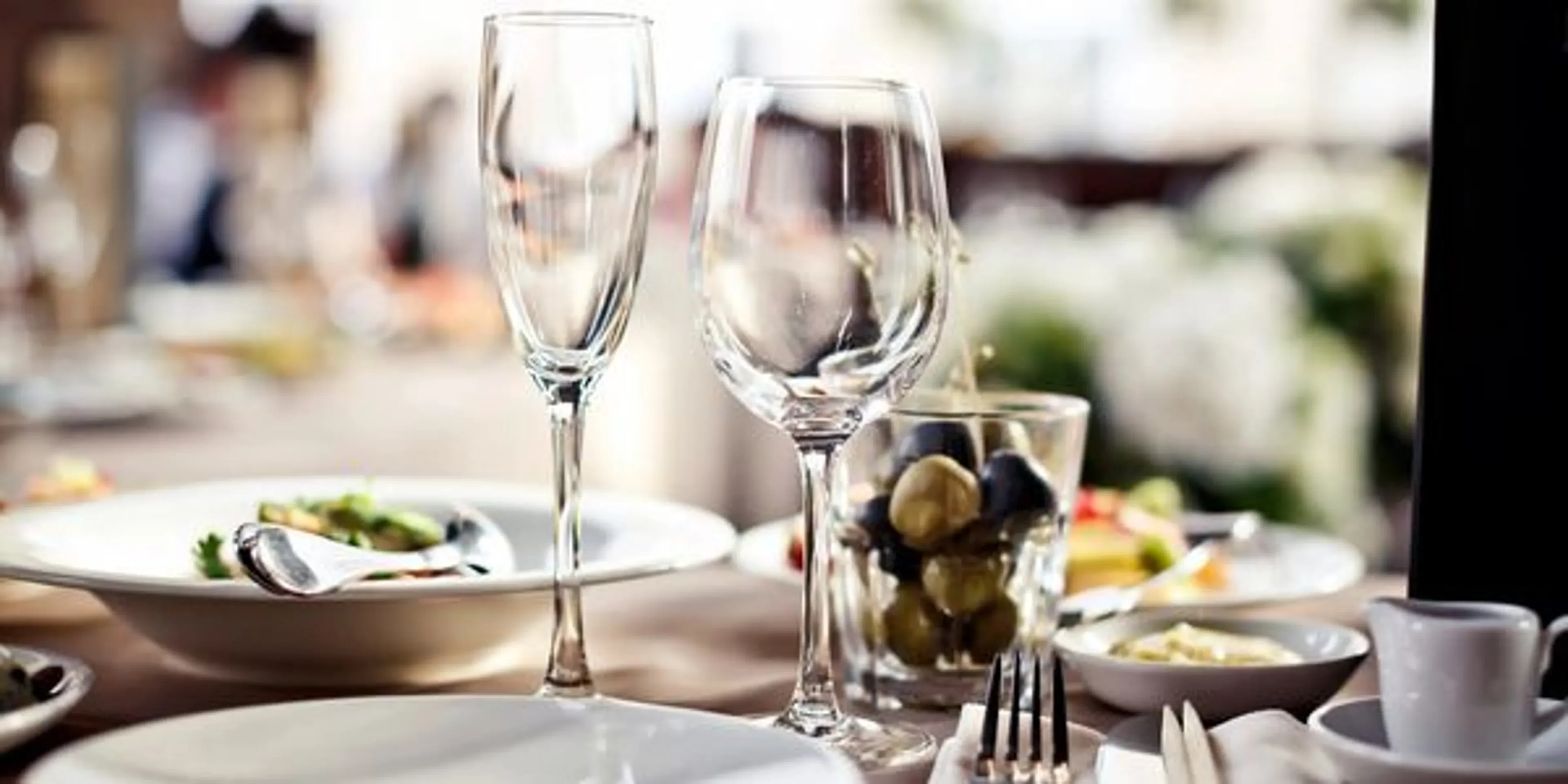 Elegant dining table set with glassware and gourmet dishes