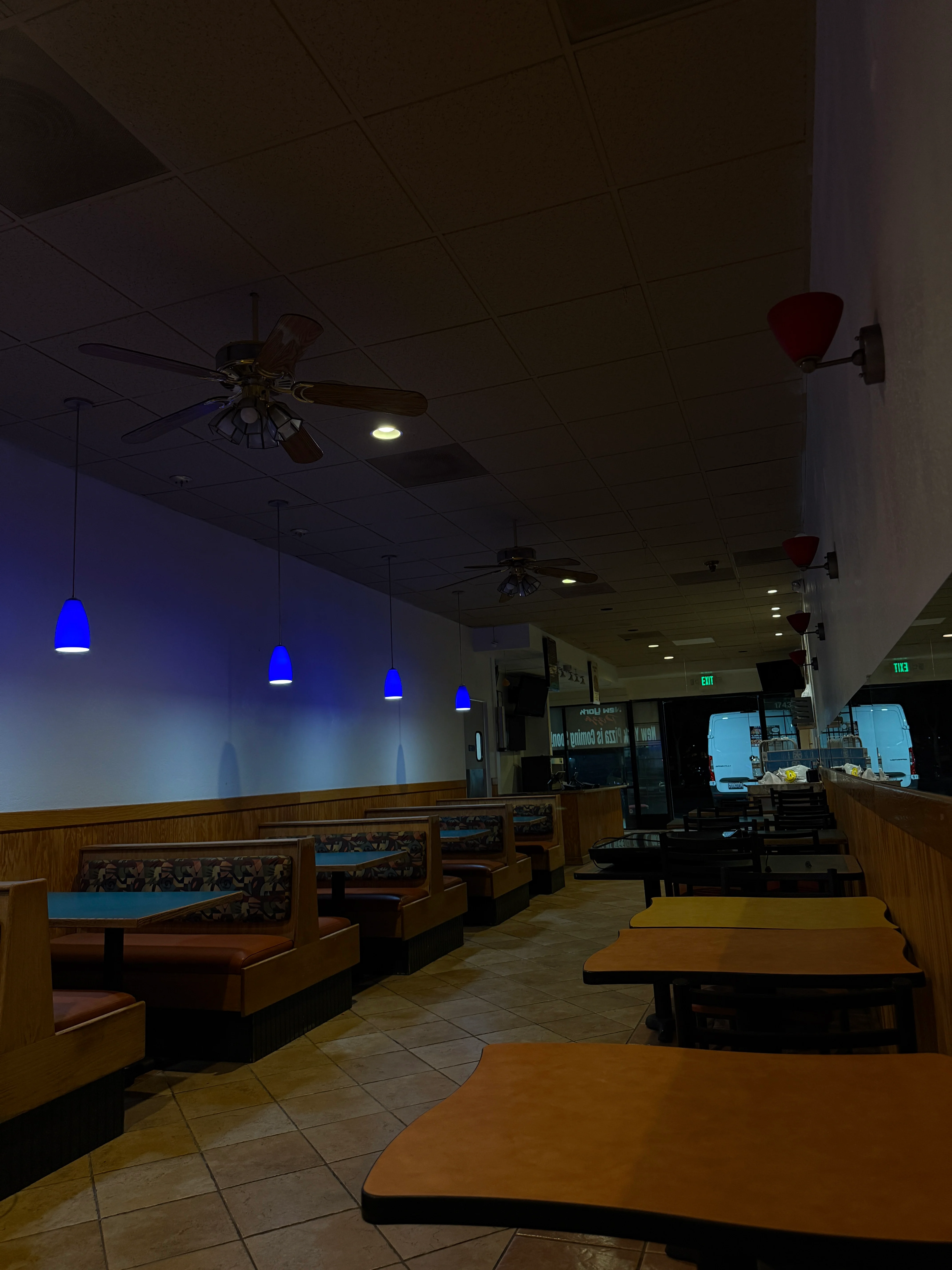 Cozy restaurant interior with blue lighting and booth seating