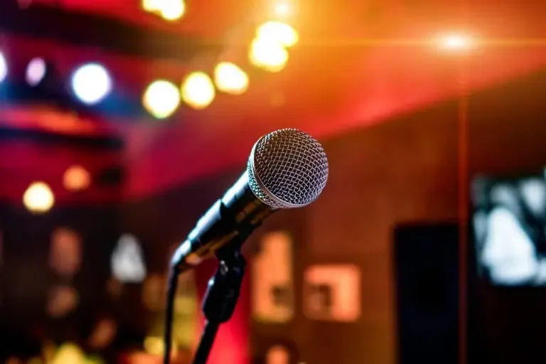 Close-up of a microphone in a vibrant performance venue