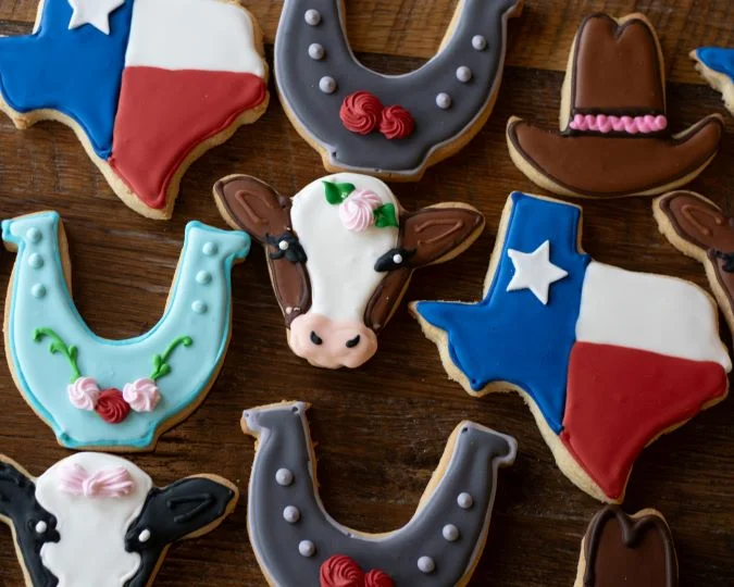 Decorative Texas-themed cookies in various shapes and colors