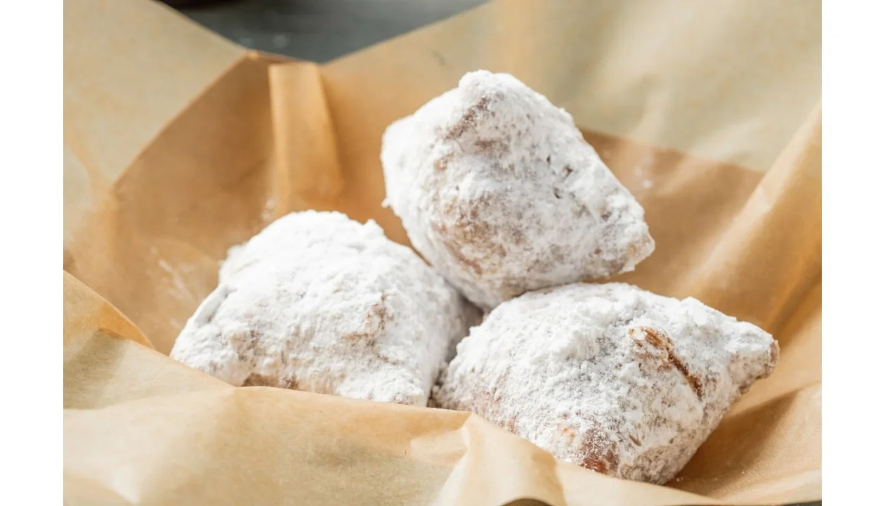 Beignets from VooDoo BBQ in Pensacola, classic New Orleans–style pastries dusted with powdered sugar.