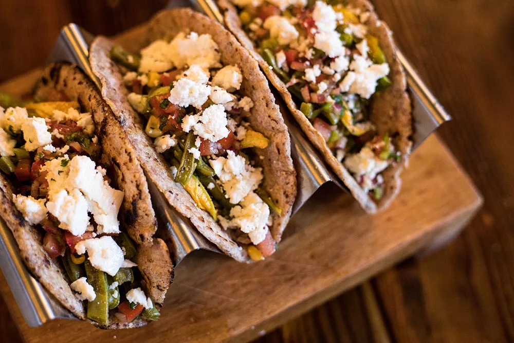 Delicious Mexican tacos filled with fresh vegetables and cheese