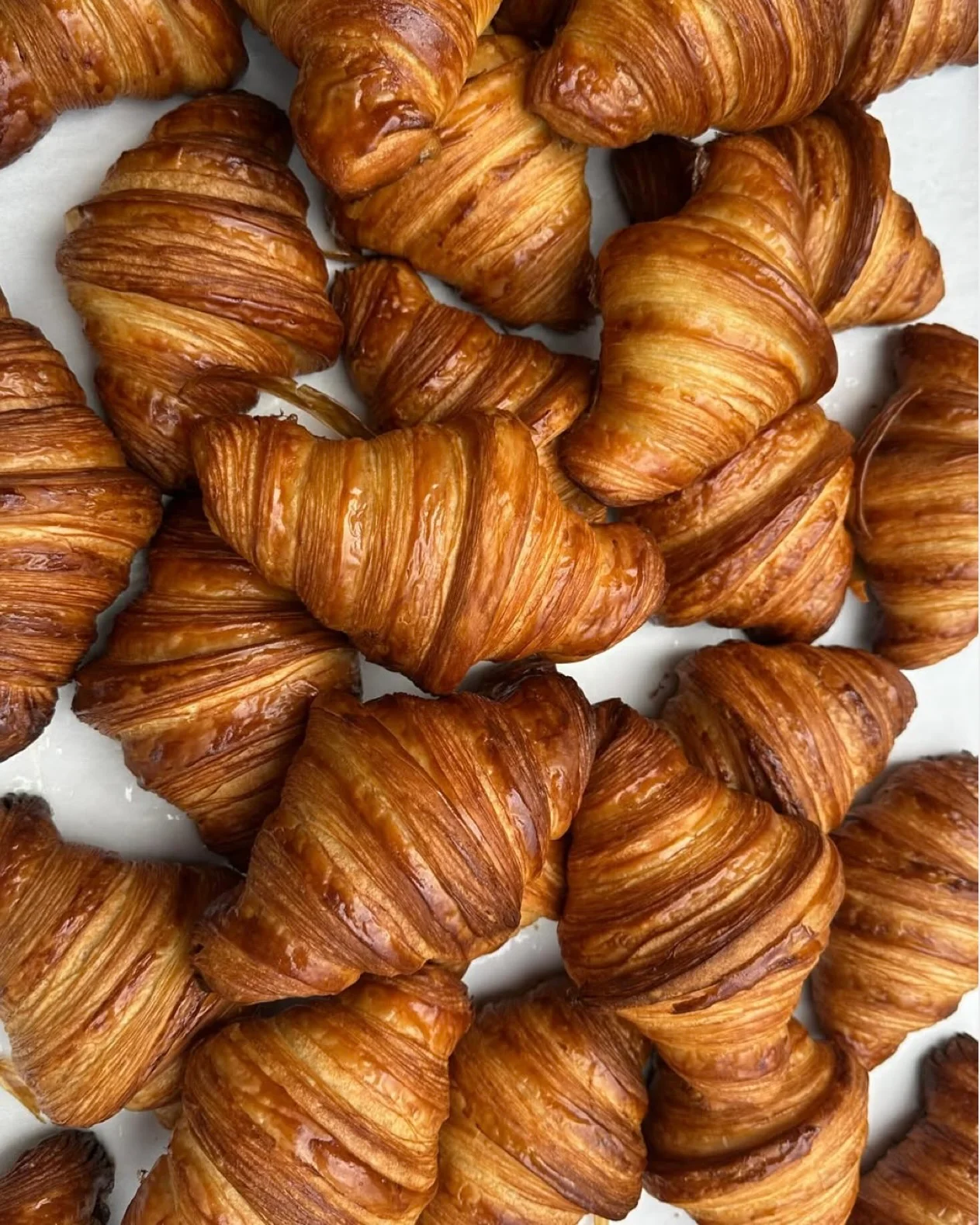 Freshly baked French croissants stacked together