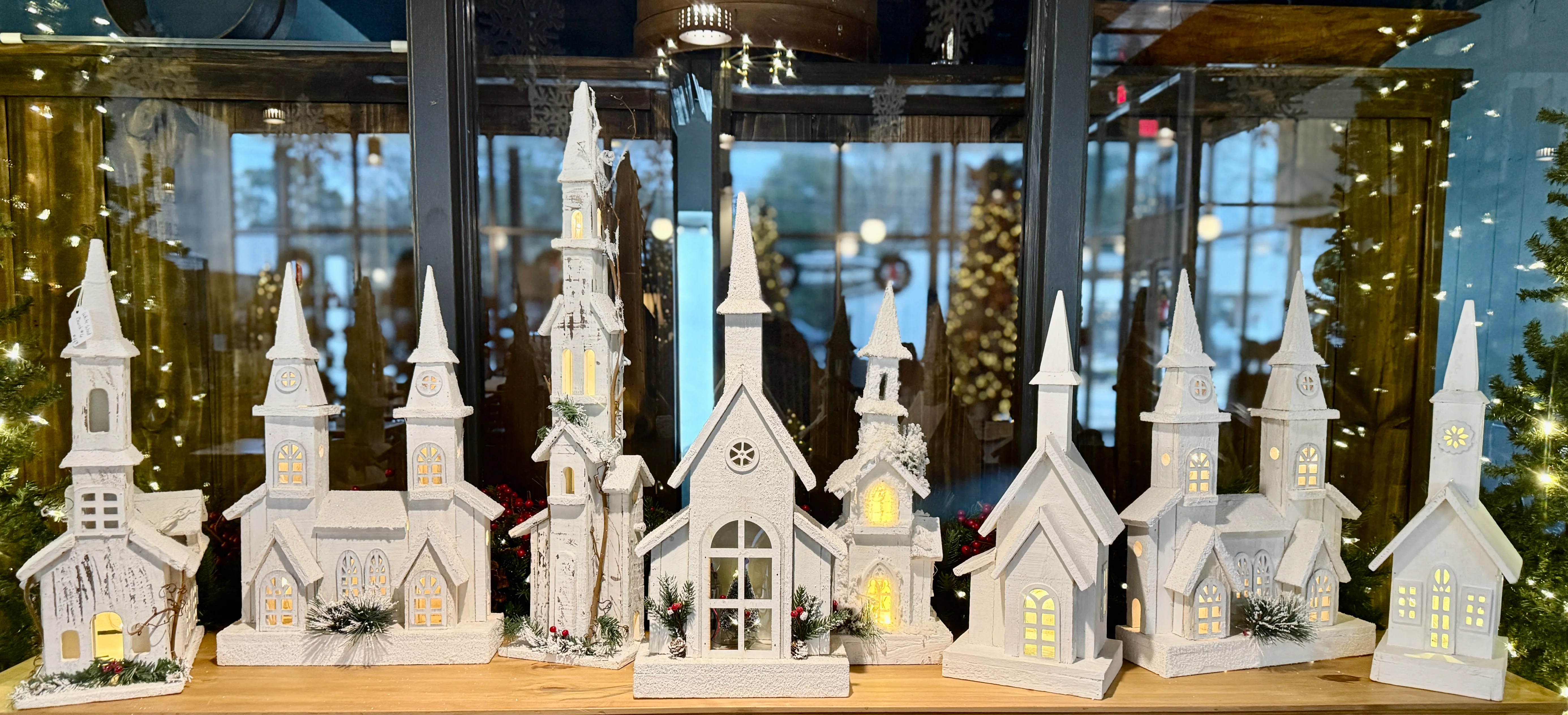 Decorative winter village display with illuminated church models