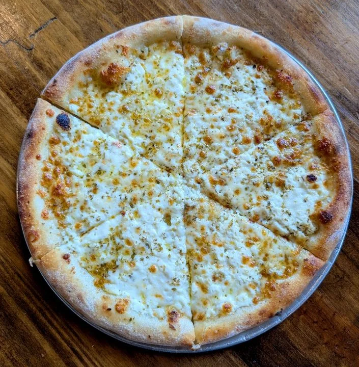 A plain cheese pizza with a golden crust, evenly sliced into eight pieces, resting on a wooden table.
