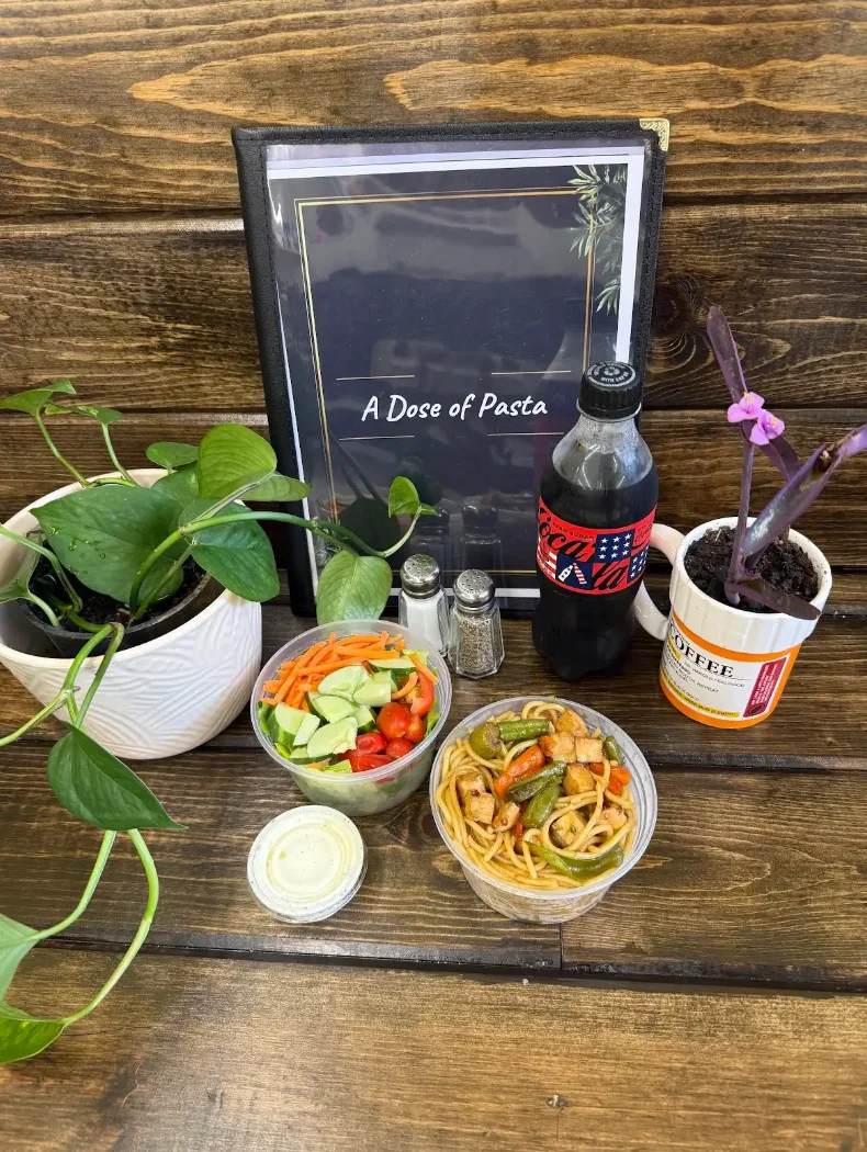 Colorful Asian stir-fried noodles with vegetables in a cozy restaurant setting