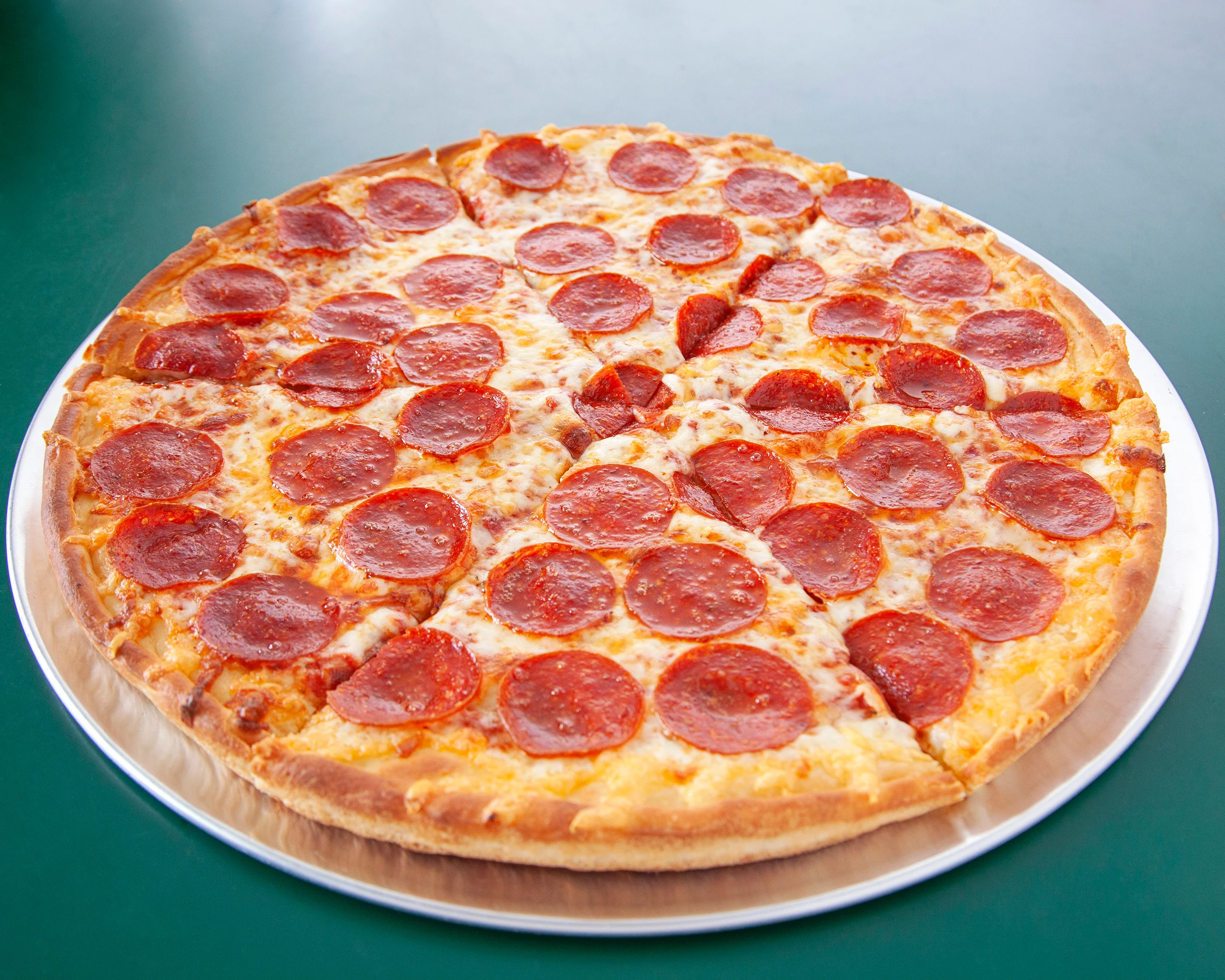 Classic American pepperoni pizza with melted cheese on a serving plate