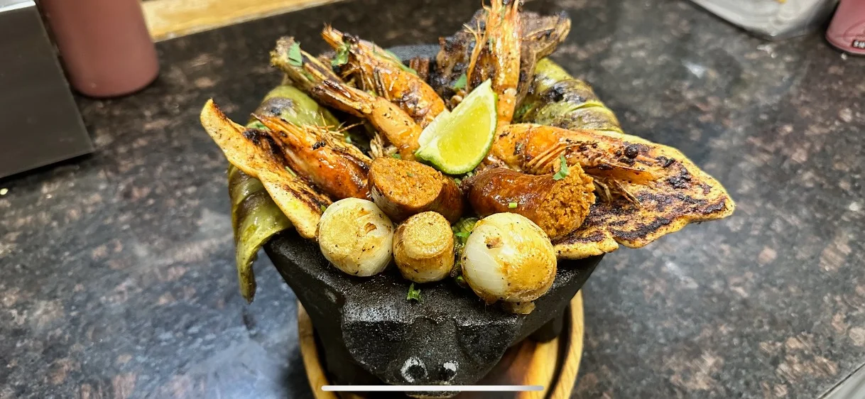 Grilled seafood platter in a traditional Mexican molcajete