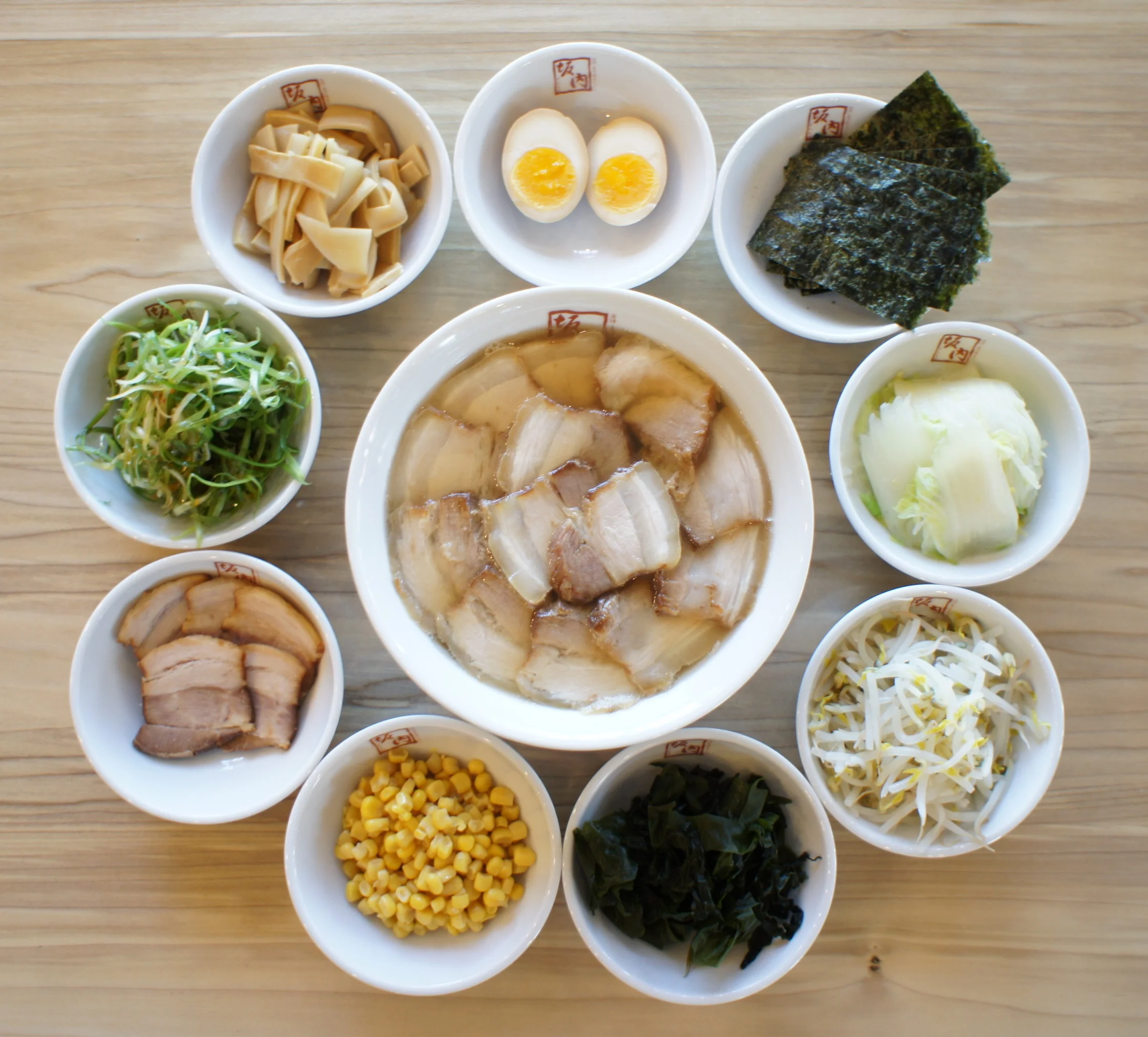Chashu Ramen with seasoned egg, shredded green onlin, corn, dried seaweed, boiled bean sprouts, cabbage, spinach, toro chashu