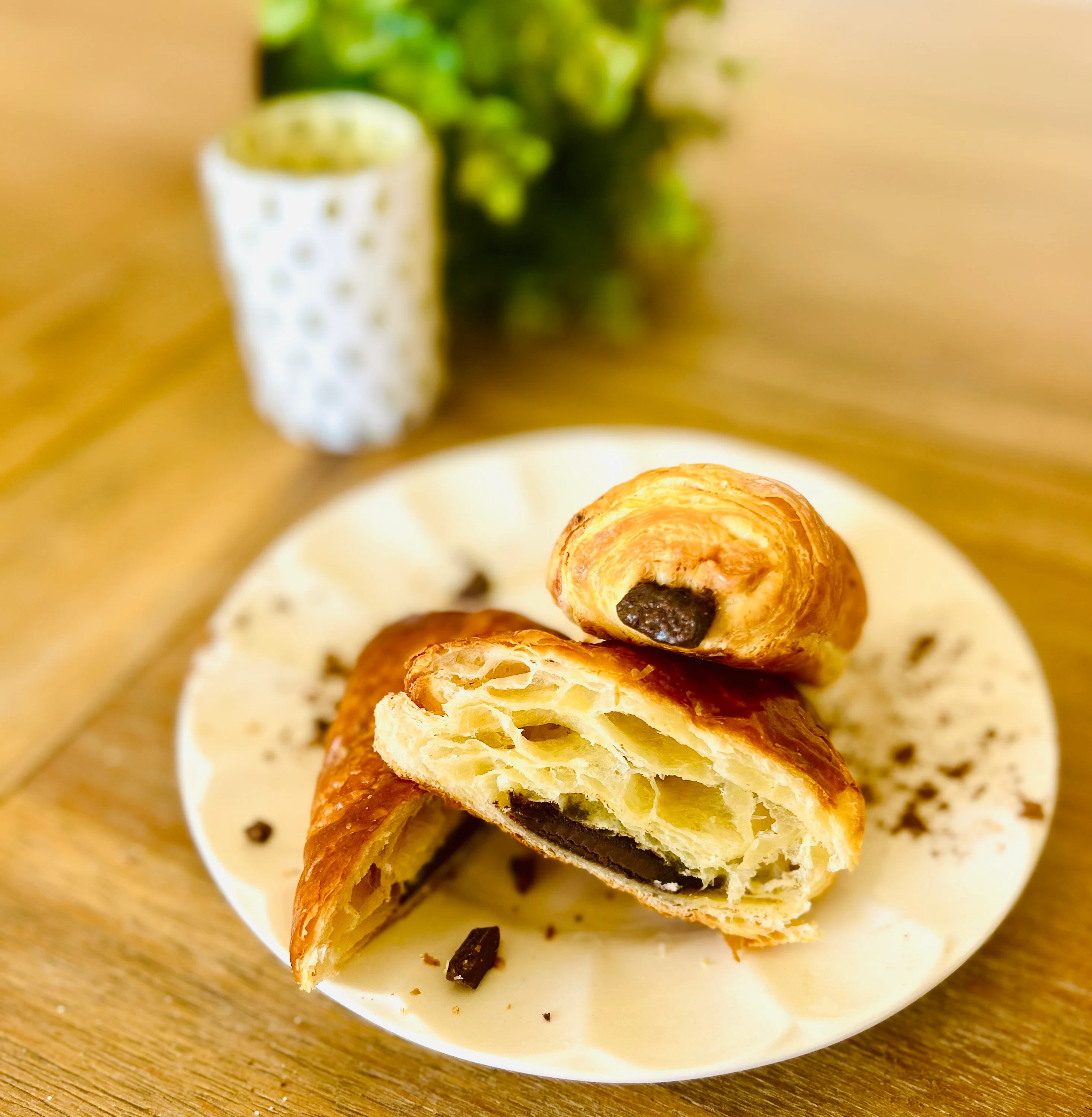 Freshly baked chocolate croissants on a plate
