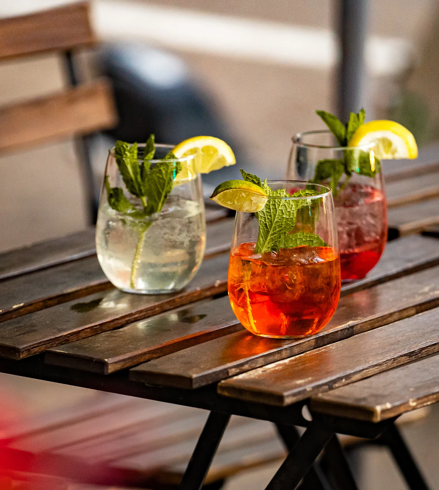 Refreshing cocktails with mint and lemon on a wooden table