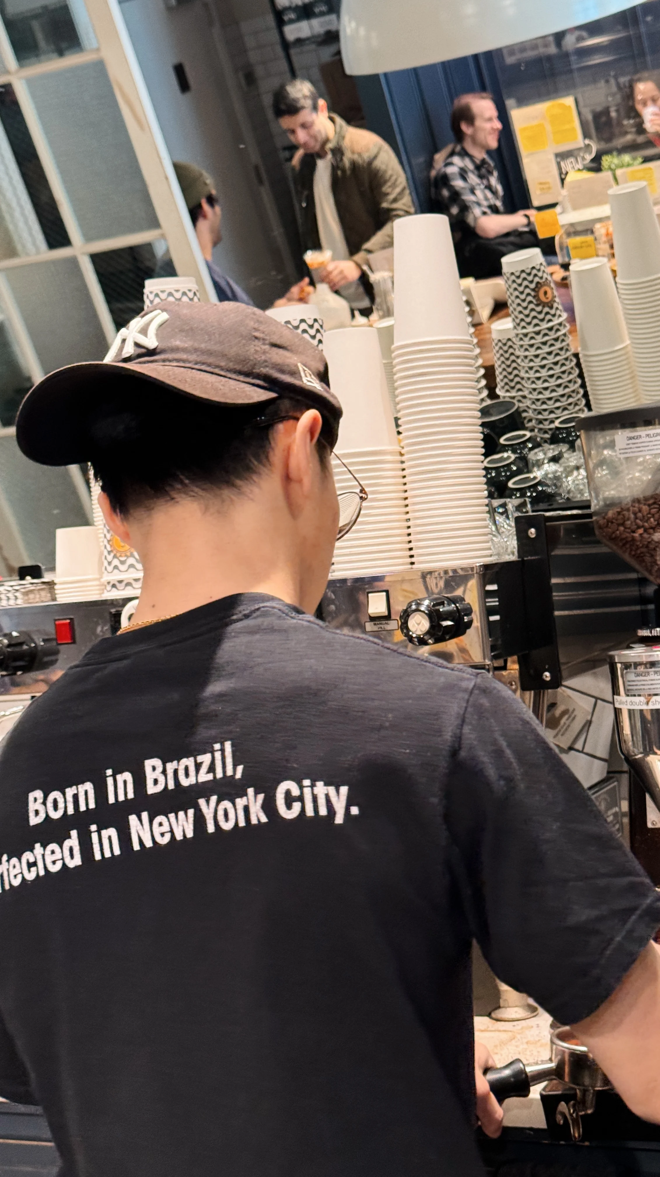 A smiling restaurant team member in a uniform, ready to serve customers.