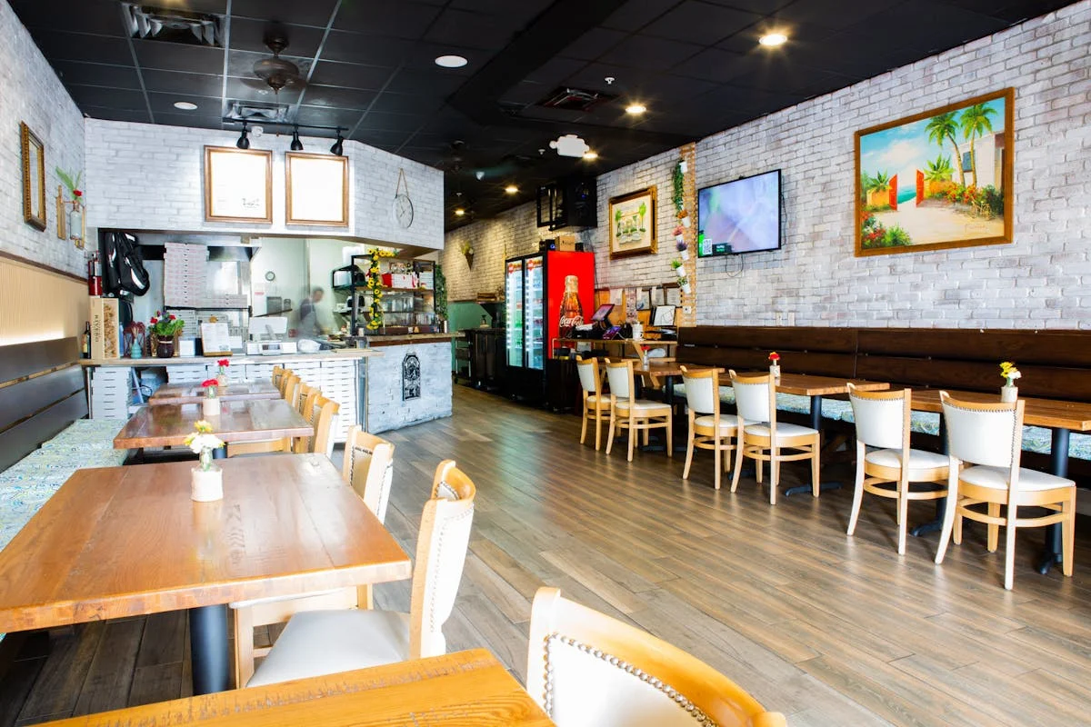 Dining room at Amici Brick Oven Pizza in West Palm Beach — cozy Italian restaurant at Village Commons