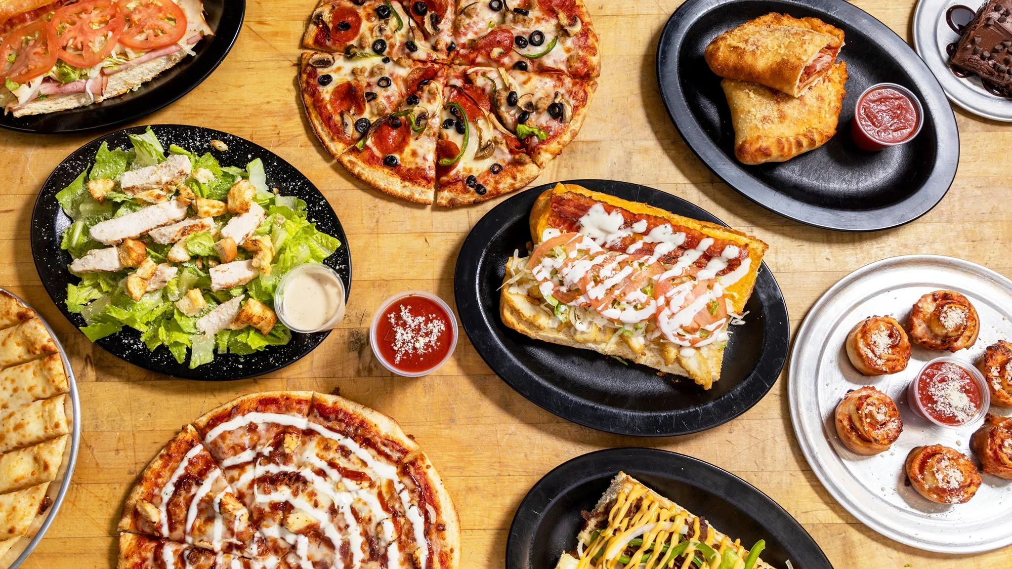 Variety of American comfort food including pizza and salad