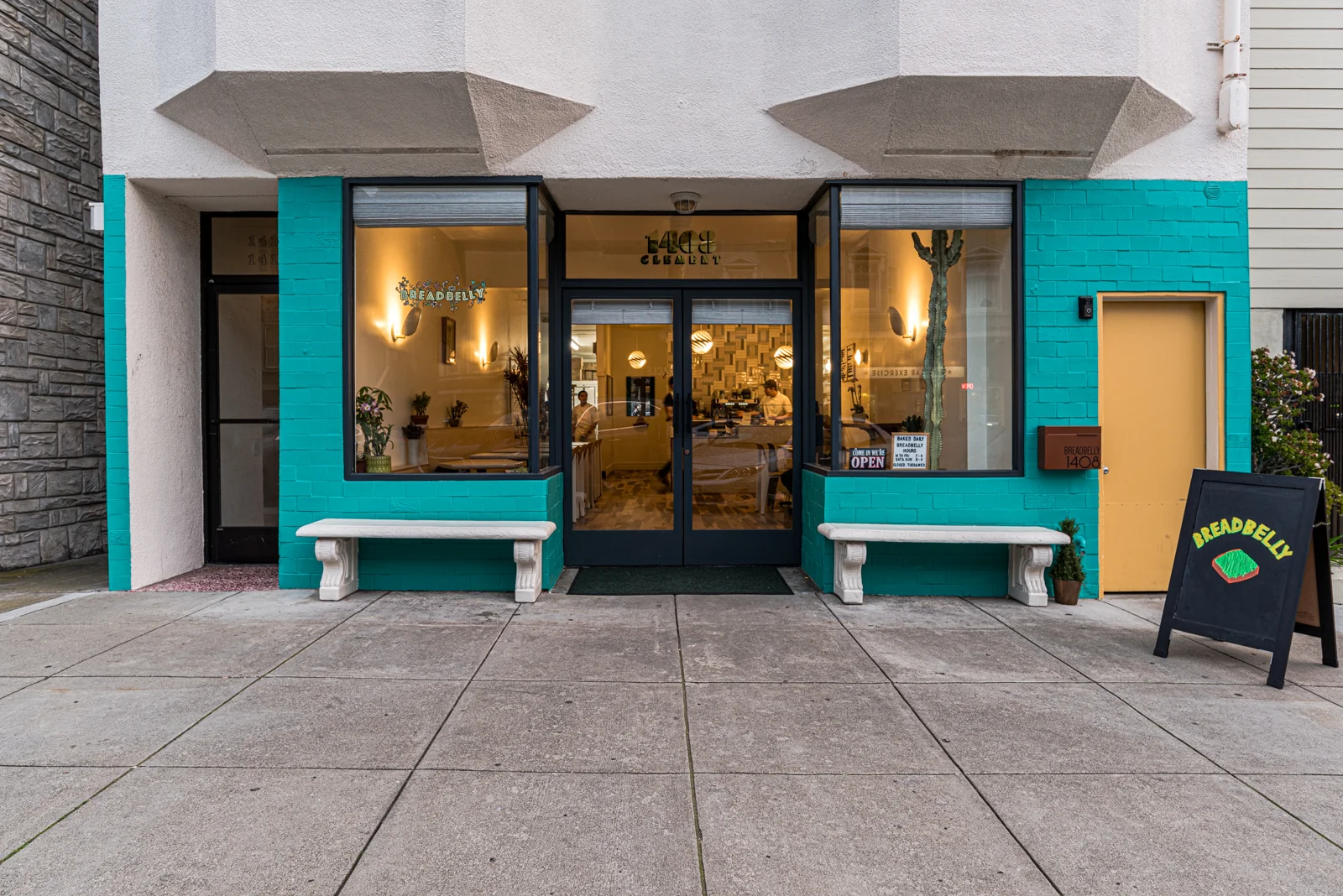 Charming restaurant entrance with teal accents and inviting atmosphere
