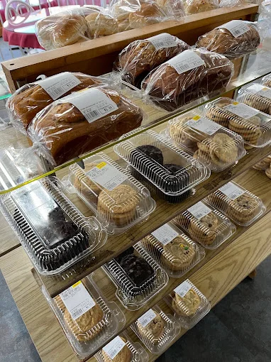 Assorted baked goods including loaves and cookies in a bakery display