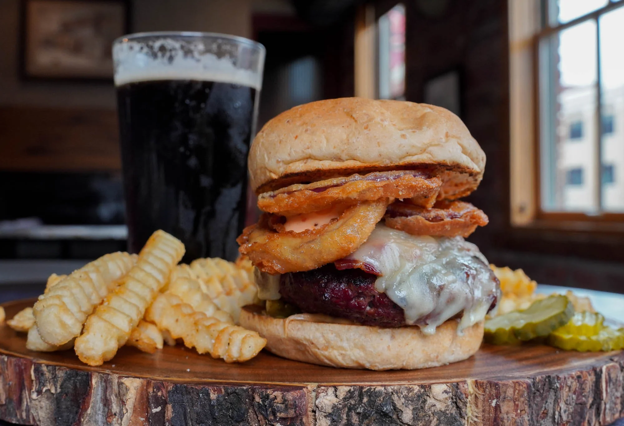 Juicy American cheeseburger with fries and craft beer