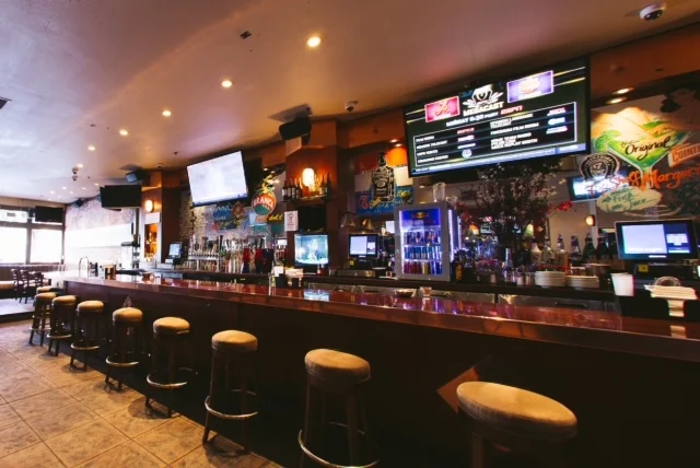 Modern bar interior with vibrant decor and seating