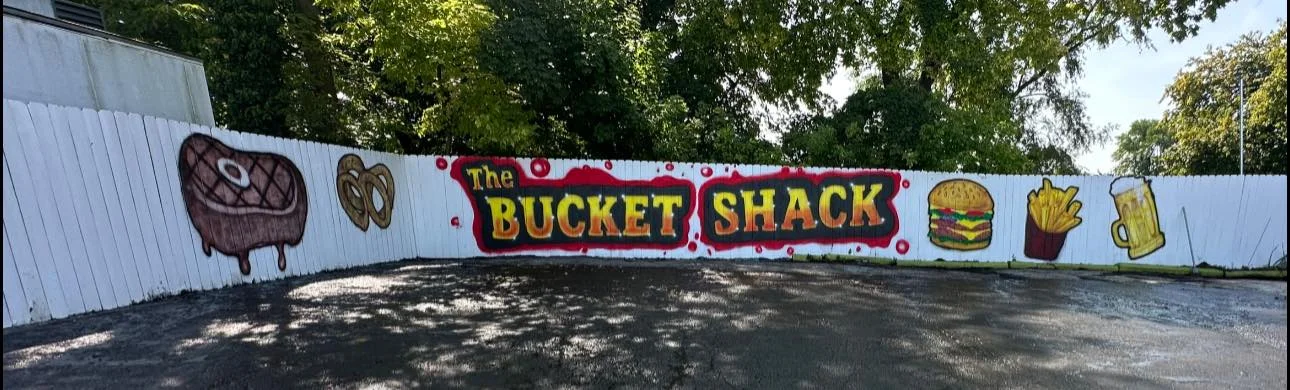 Colorful mural of The Bucket Shack featuring food icons